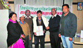 Deepak Kumar, director of the Manthan Art Group, receives the State Youth Award 2010-11 from the Additional Deputy Commissioner, Sonepat, SB Lohia (second from right) at a programme in Sonepat.
