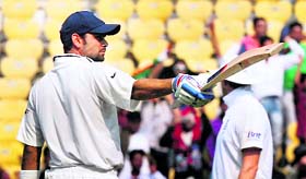 Virat Kohli raises bat after completing the century (103).