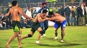 An Indian raider (in blue) scores a point during the final win (59-22) on Saturday.