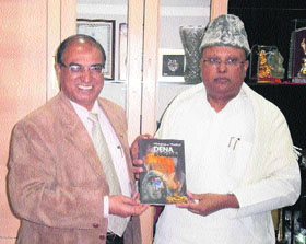 Swami (Dr) Parthasarathy (right) along with Prof (Dr) MM Goel, an economics professor at KU, releases the drama book �Dena-Paona (Debit-Credit)�.