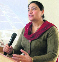 Tejinder Pal Kaur, Principal, E-max International School, addresses participants at a seminar on World Energy Conservation Day.