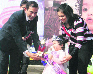 The super baby of the baby show being awarded by the chief guest at DPS, Yamunanagar.