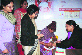 Additional Deputy Commissioner Sumedha Kataria (second from left) and Civil Surgeon Vandana Bhatia (extreme left) watch as a health worker administers pentavalent vaccine to a child in LNJP Hospital, Kurukshetra.