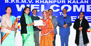 The Vice-Chancellor of Bhagat Phool Singh Women University, Khanpur Kalan, Dr Pankaj Mittal, gives away a prize to a student of the university�s campus school at the annual day function of the school.