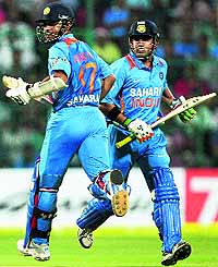 Gautam Gambhir and Ajinkya Rahane complete a run during the 1st T20 match against Pakistan in Bengaluru on Tuesday