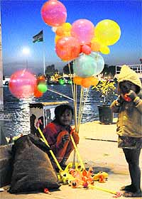 Children sell balloons on a chilly evening in Kurukshetra