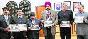 Lt Gen (Dr) DDS Sandhu (third from right), Vice-Chancellor, Kurukshetra University, releases the KU Desk Calendar -2013 in his office