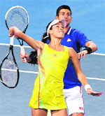 Novak Djokovic, Ana Ivanovic of Serbia share a laugh in their match against Andreas Seppi and Francesca Schiavone of Italy during the Hopman Cup in Perth. � Reuters 