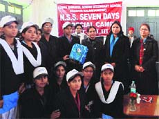 The Vice-Chancellor, Dr Pankaj Mittal (second from right), and the Registrar, Dr Asha Kadian (right), with NSS volunteers who won prizes in a seven-day special camp. 