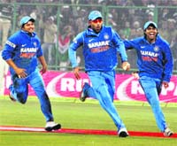 Suresh Raina, Yuvraj and Ravindra Jadeja (left to right) celebrate victory at Ferozshah Kotla Stadium