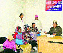 A police official interacts with complainants at the women and child desk of a police station in Kurukshetra