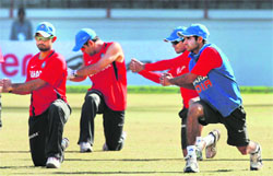 India�s players and Dhoni (above) train in Rajkot.