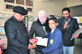 Bright spark: HS Chahal, Vice-Chancellor of Murthal University, gives away a prize to a winner of Poster on Road Safety at a function on the university premises