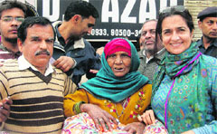 The Haryana Public Health Engineering Minister, KIran Chaudhary, gives away quilts to poor people at a function in Bhiwani. A Tribune photograph