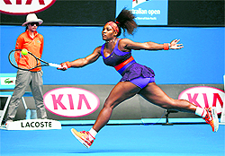 Serena Williams hits a sweeping forehand on the move