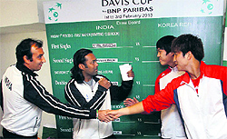 Indian and South Korean players shake hands after the draw for their Davis Cup clash was made in New Delhi on Thursday