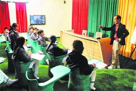 Japanese teacher Tatsushi Funahashi interacts with students during a workshop on the Japanese language and culture at Wisdom World School, Kurukshetra, recently