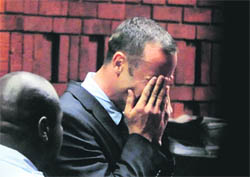 Oscar Pistorius breaks down in court on Friday after being charged with the murder of his girlfriend.