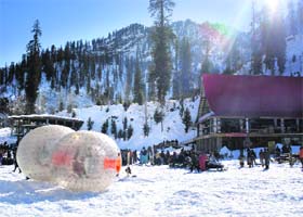 Adventure sports lovers get ready to try out zorbing in a snow-laden valley