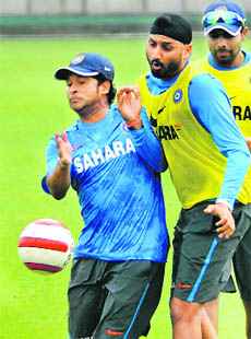 Sachin Tendulkar horses around with Harbhajan Singh on Tuesday. 