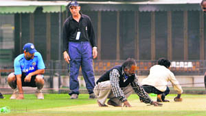 MS Dhoni takes a look at what the PCA curator Daljit Singh has in store for him in the third Test. 
