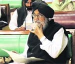 The CM reads a Budget document in the assembly.