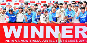 The Indian team strikes a victorious pose after winning the Border-Gavaskar Trophy on Sunday. 