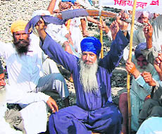 a farmer with his sword, at Mananwala railway station near Amritsar on Friday.