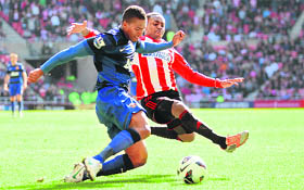 Manchester United's Antonio Valencia and Sunderland's Danny Rose in action during their match on Saturday.