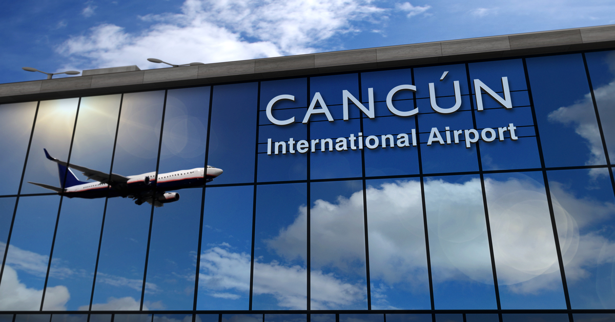 cancun airport facade with plane reflected