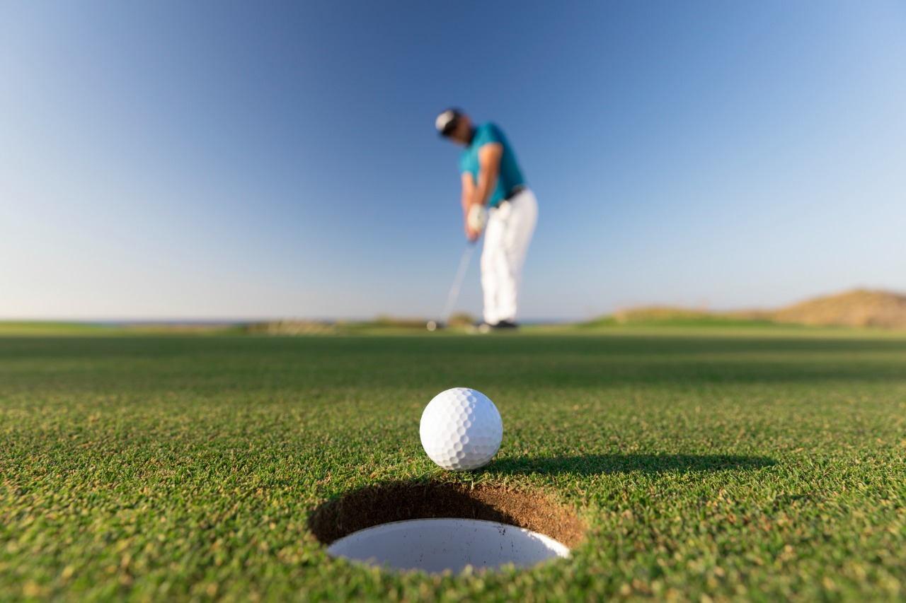 Golf ball entering the hole