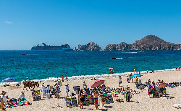 Tourists on the beach with cruise ship on the background