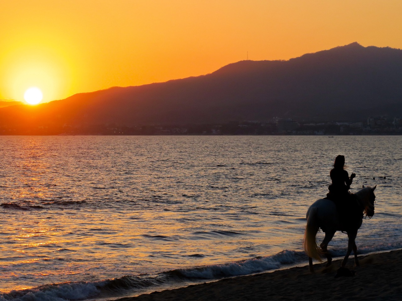 horseback riding at sunset in quaint town in Riviera Nayarit