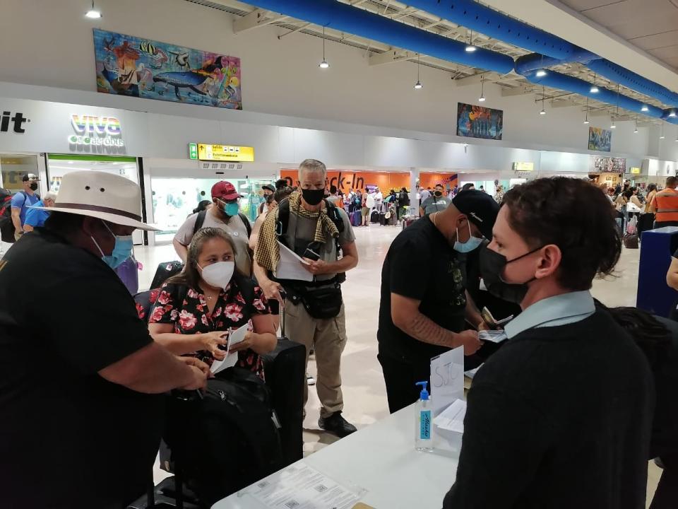 passengers in an airport wearing masks