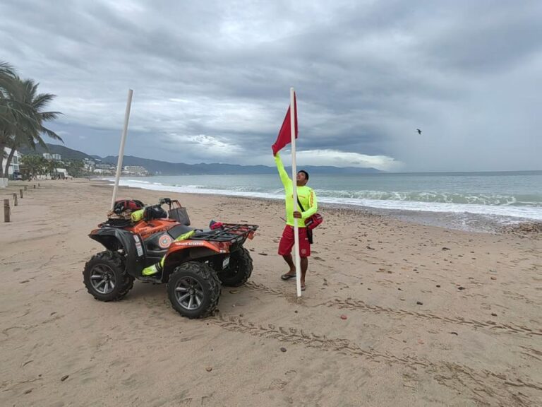 puerto vallarta beach with red flag and lifeguard
