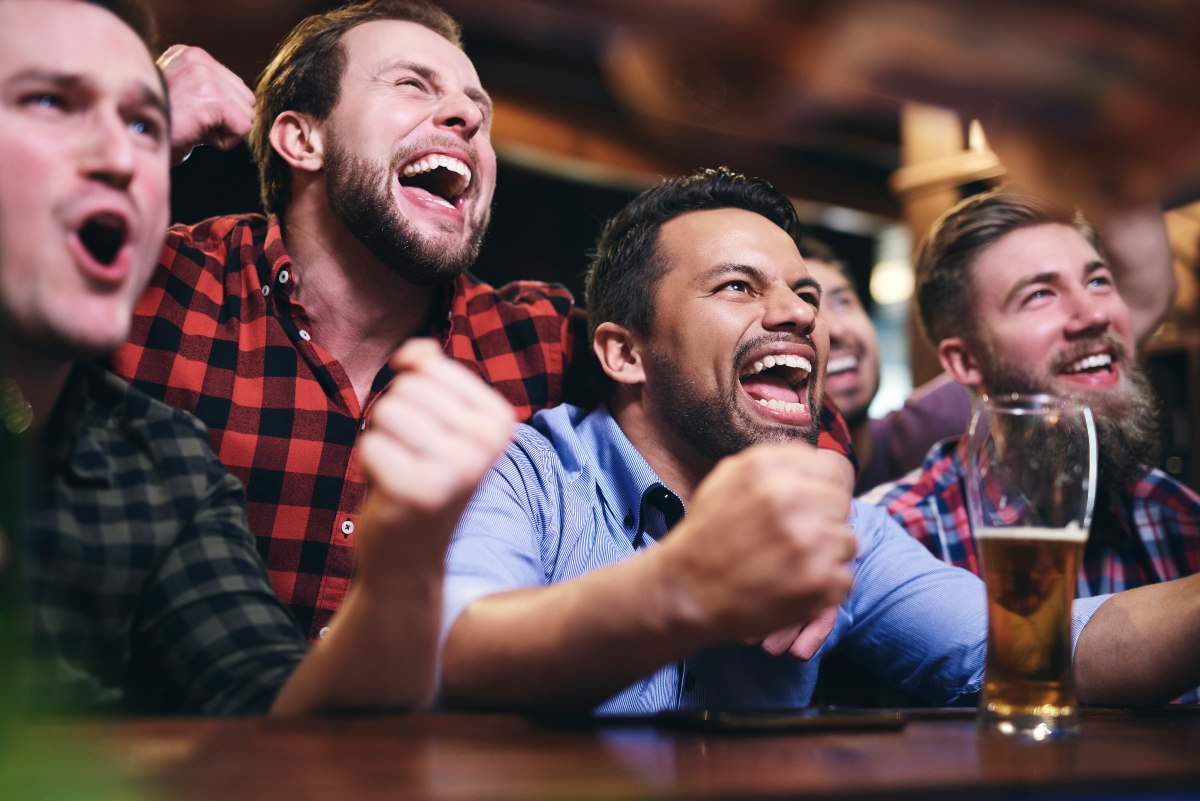 people celebrating a touchdown in a bar