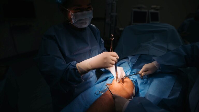 doctors operating a patient with arthroscopy