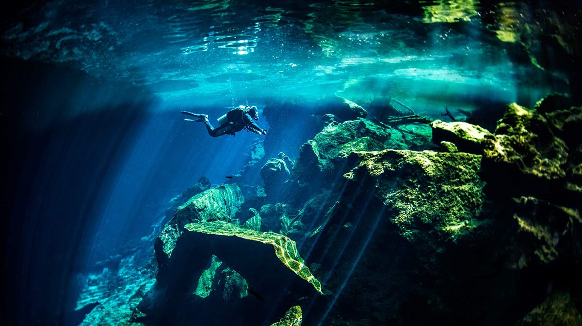 diver exploring a cenote near Cancun