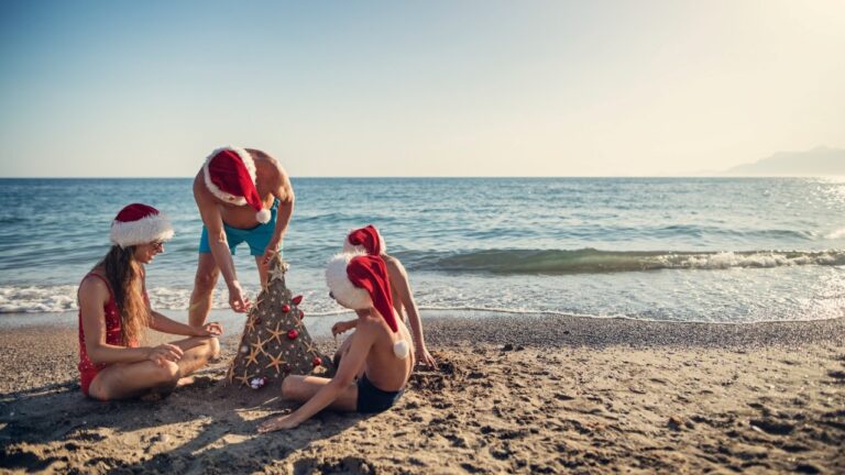 a family with Christmas caps on a Cabo San Lucas beach