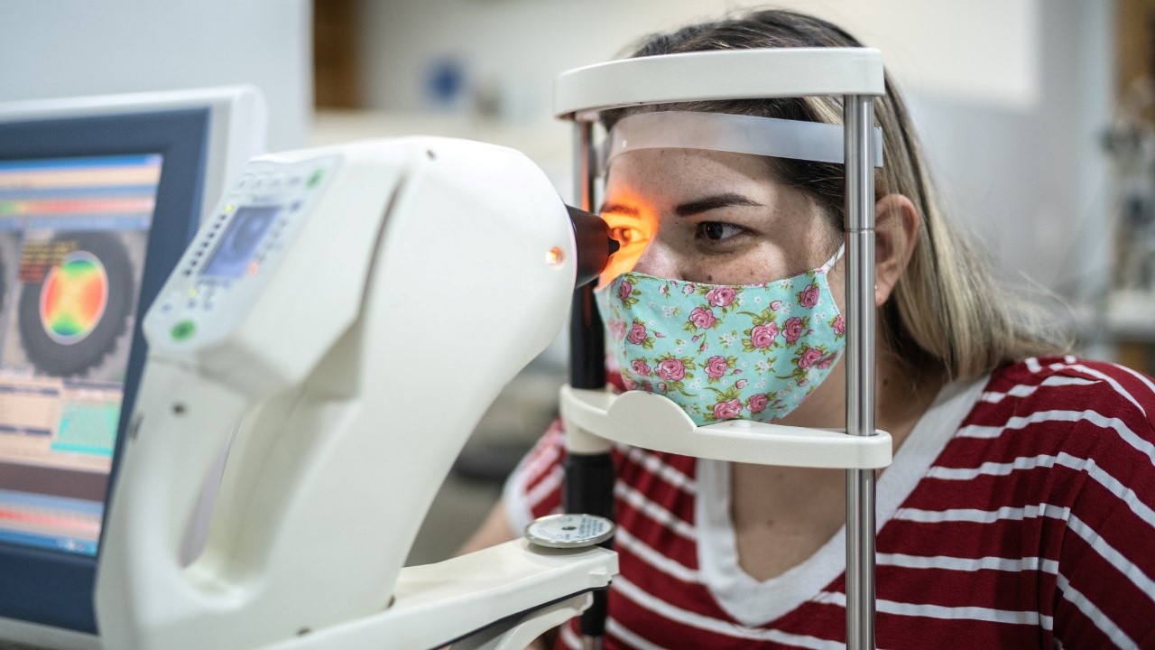 Woman with a facemask taking an eye exam