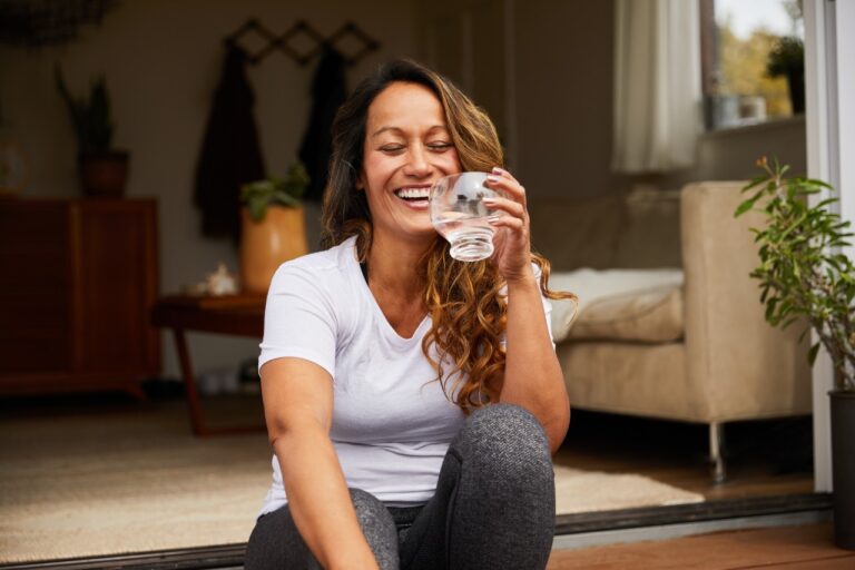 woman holding a glass of water