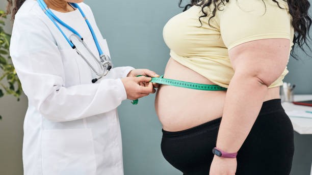 Physician measuring an overweight woman