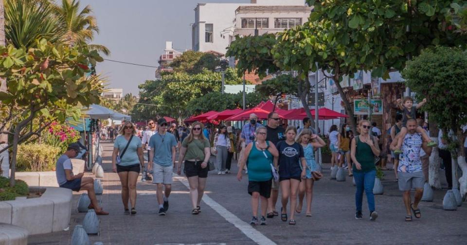 travelers walking along Puerto Vallarta Malecon