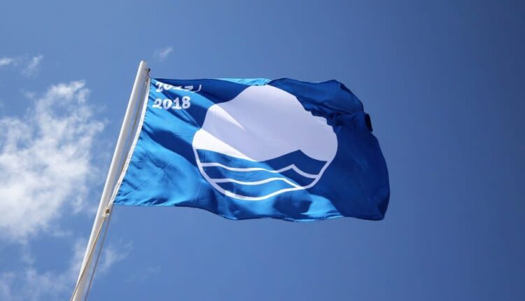 blue flag waving on a post