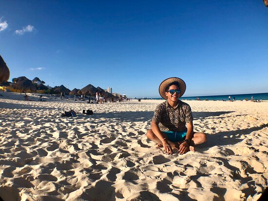 man sitting on the beach in Cancun