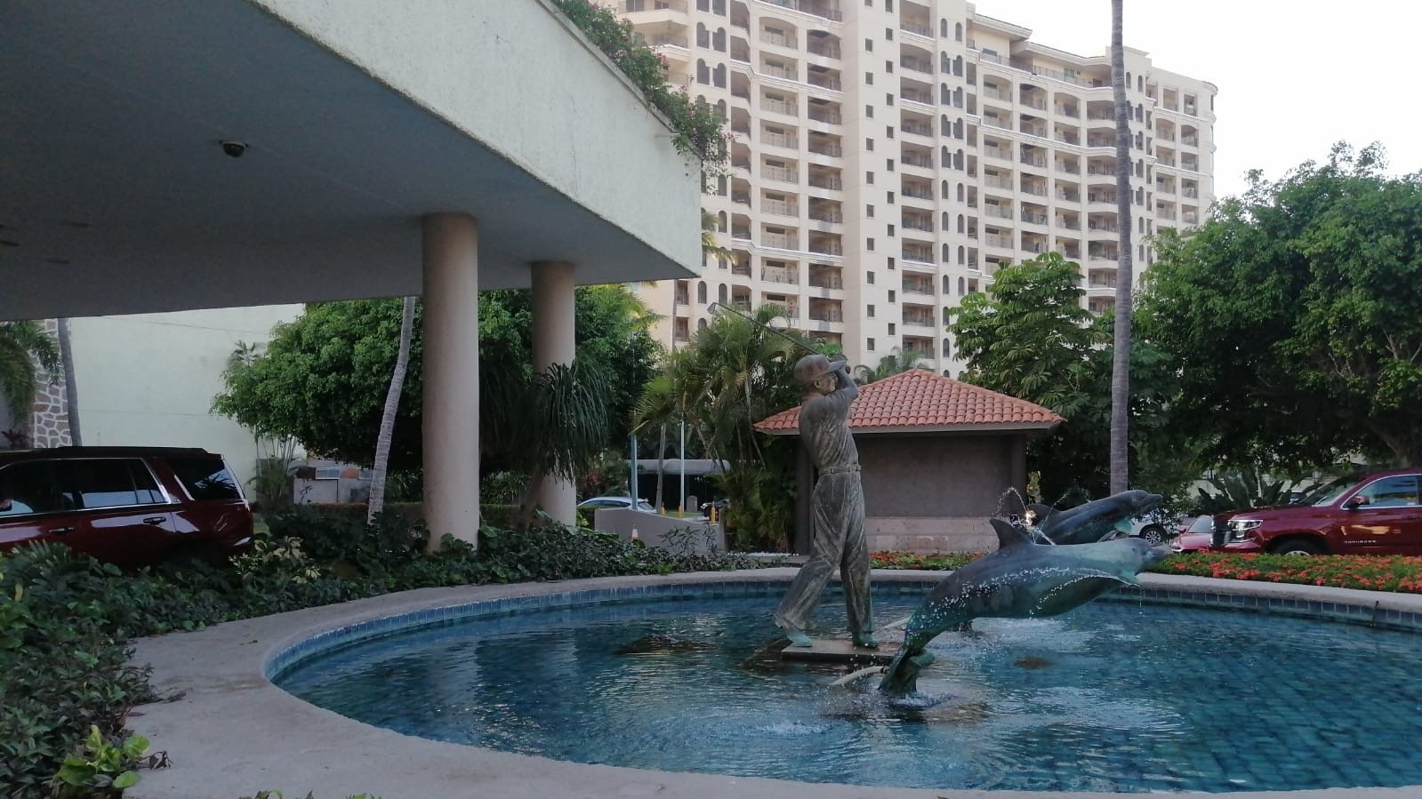 Fountain of golfer sculpture with dolphins by the side