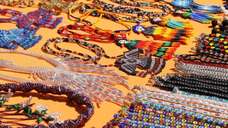 pieces of huichol art on a yellow cloth