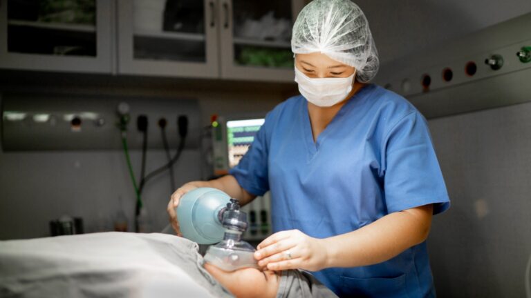 anesthesiologist applying anesthesia to a patient