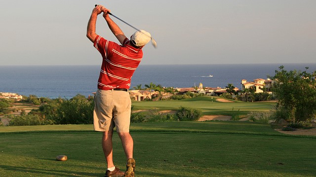 Golfer swinging on a Los Cabos golf course