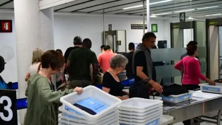 passengers lining at security check point at airport